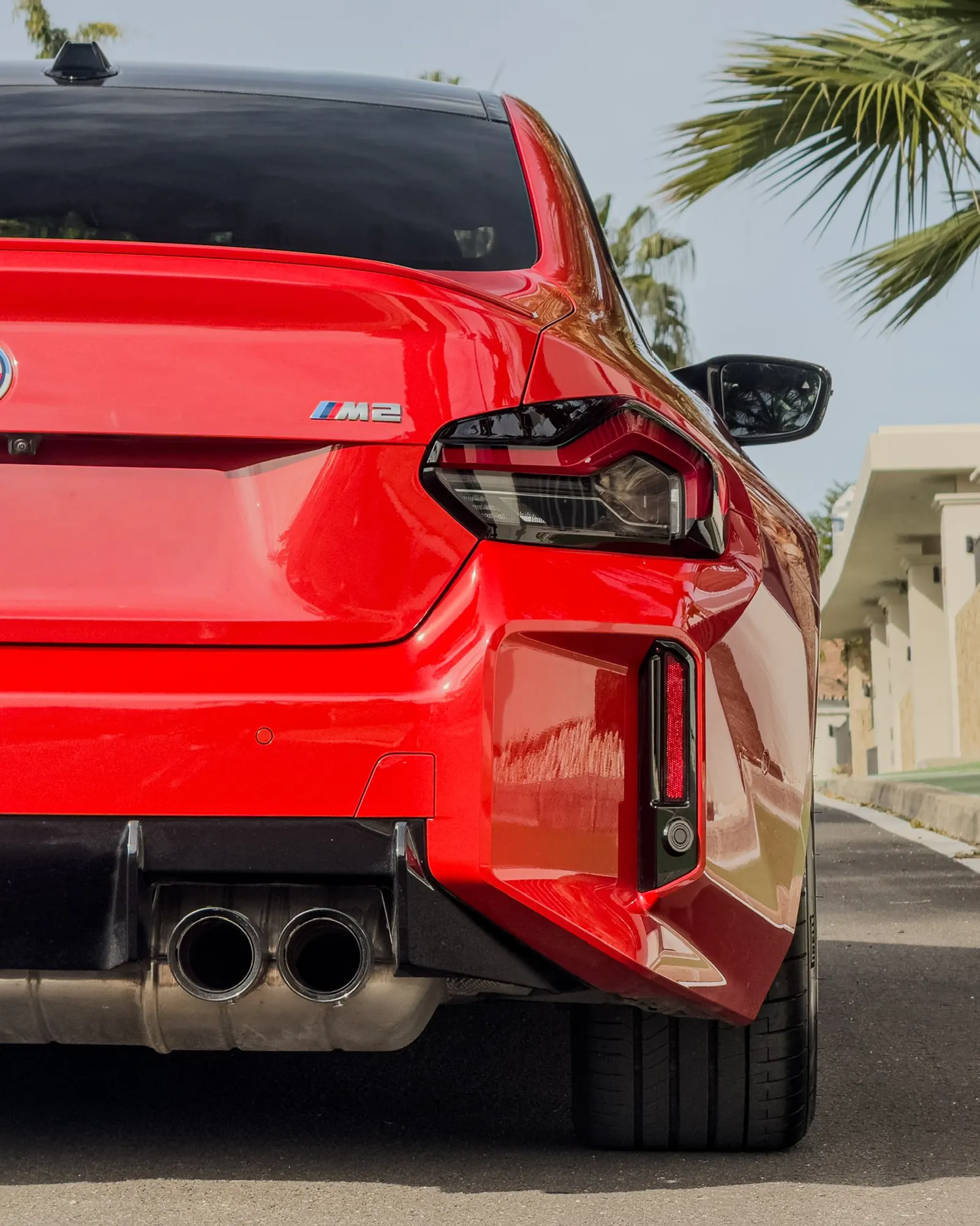 BMW M2 G87 rear detail with M2 badge, LED tail lights, dual exhaust and sport diffuser