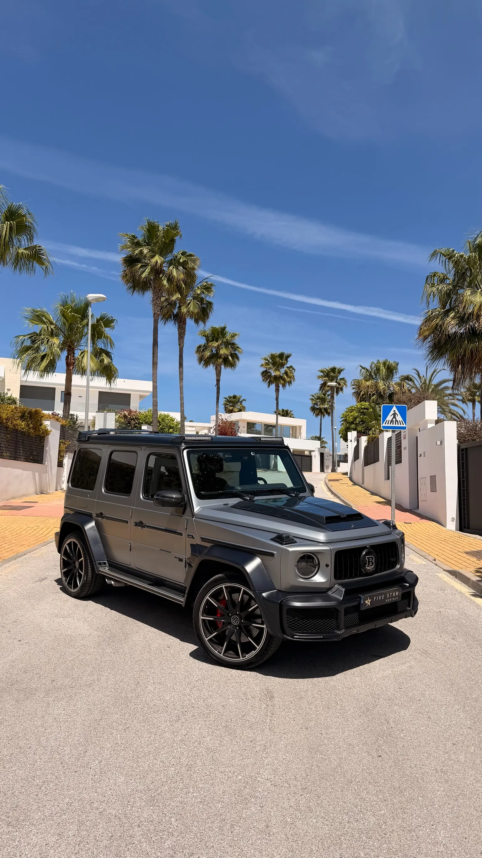 Mercedes-AMG G63 Brabus Kit matte grey, front three-quarter view with Five Star Rentals badge in Marbella