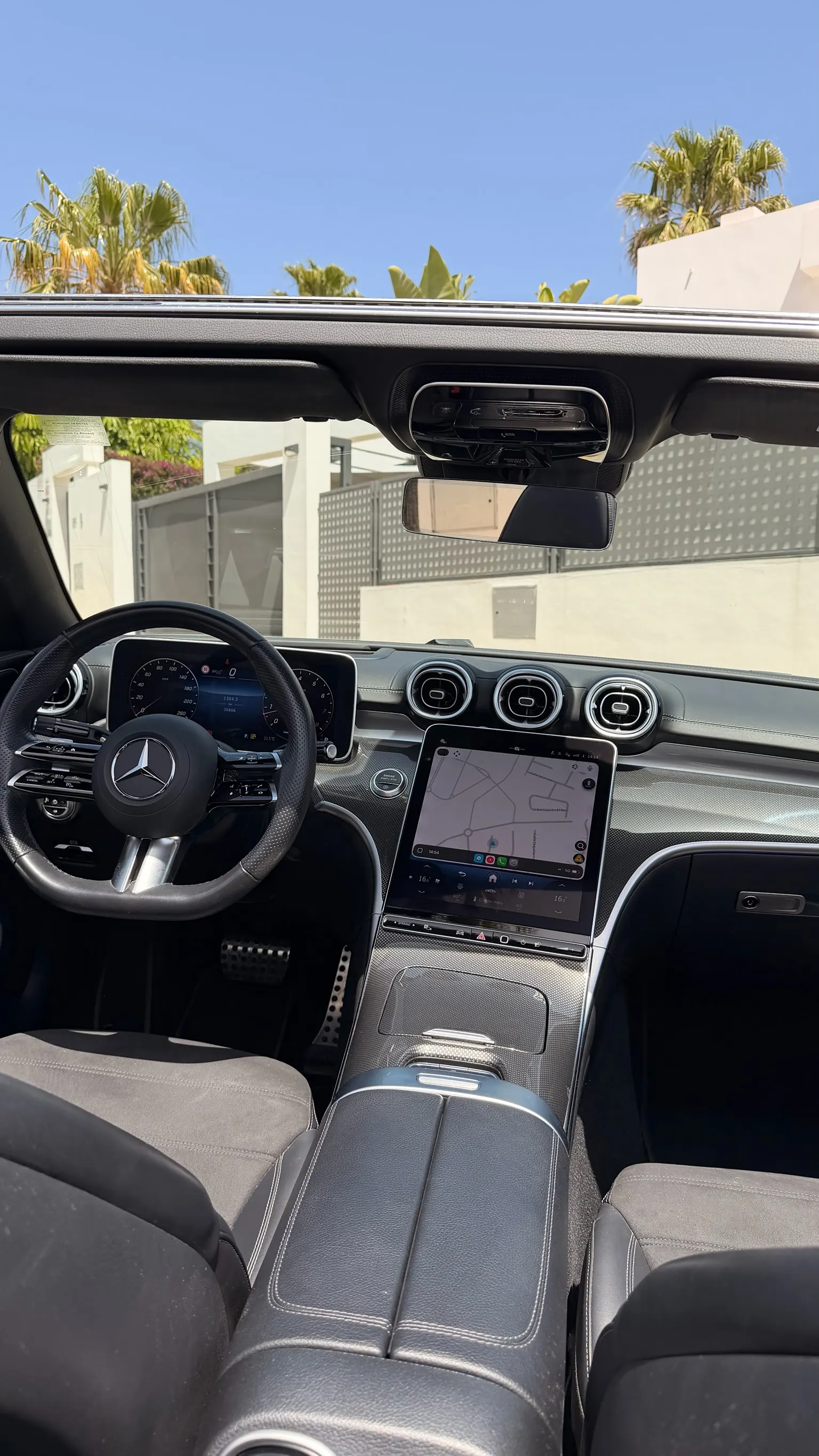 Mercedes CLE 200 Cabriolet cockpit with AMG steering wheel, 12.3-inch digital instrument cluster, 11.9-inch portrait MBUX touchscreen and three round air vents